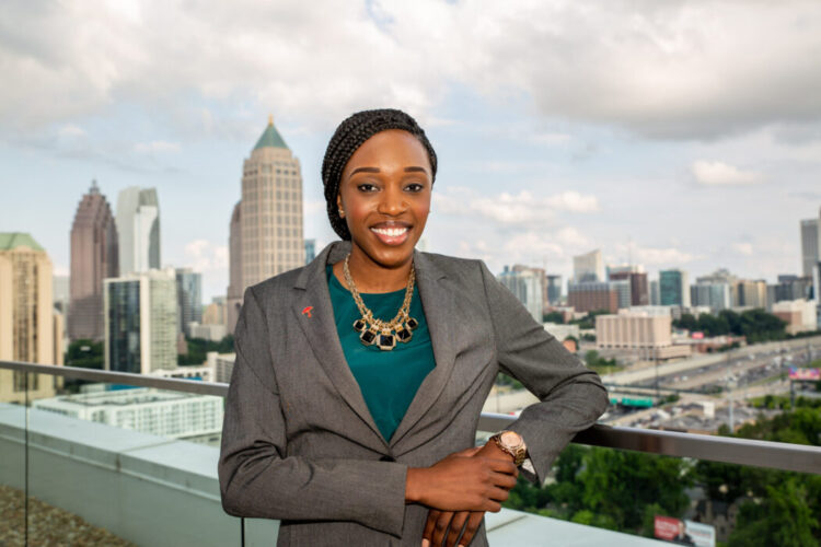 Female student standing in front of a cityscape