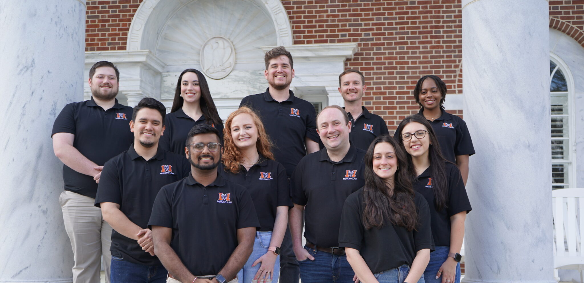 Group of students in black Mercer Law polos