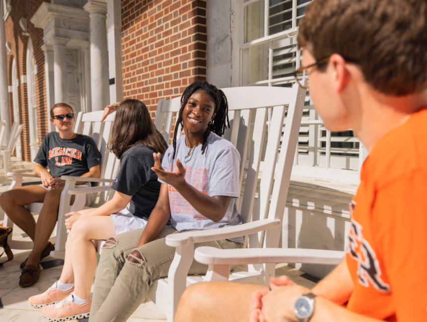 Students talking and laughing on Mercer Law's front porch