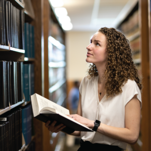 Woman reading a book in a law library