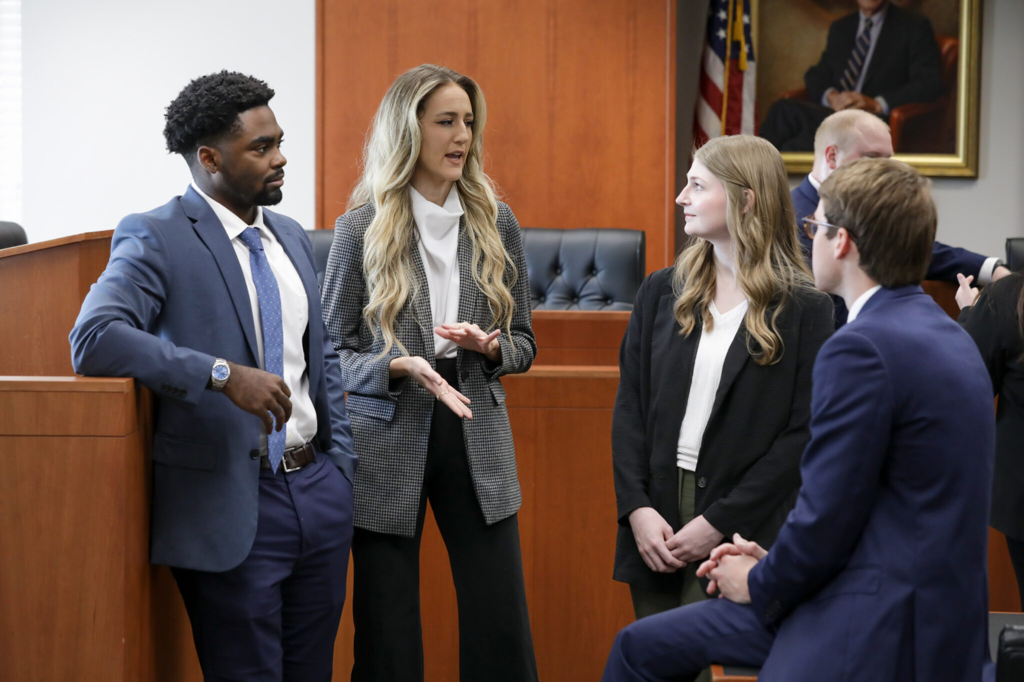 Students talking in a mock courtroom