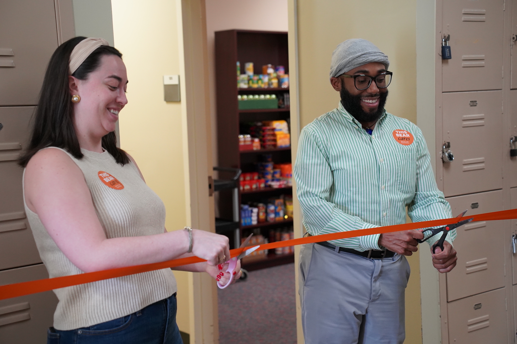 SBA President Katherine Twomey and Director of Admissions & Financial Aid Antonio Squire cut a ribbon for the food pantry