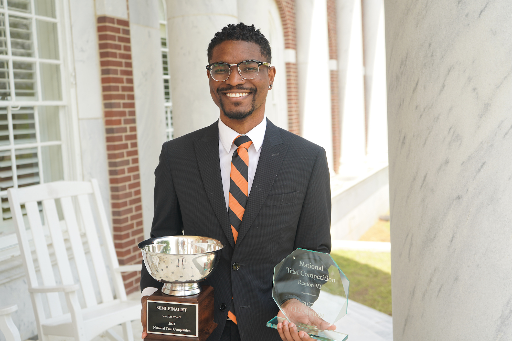 Isiah Chavis holding trophies