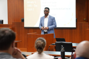 Vernon Strickland stands behind a podium addressing students