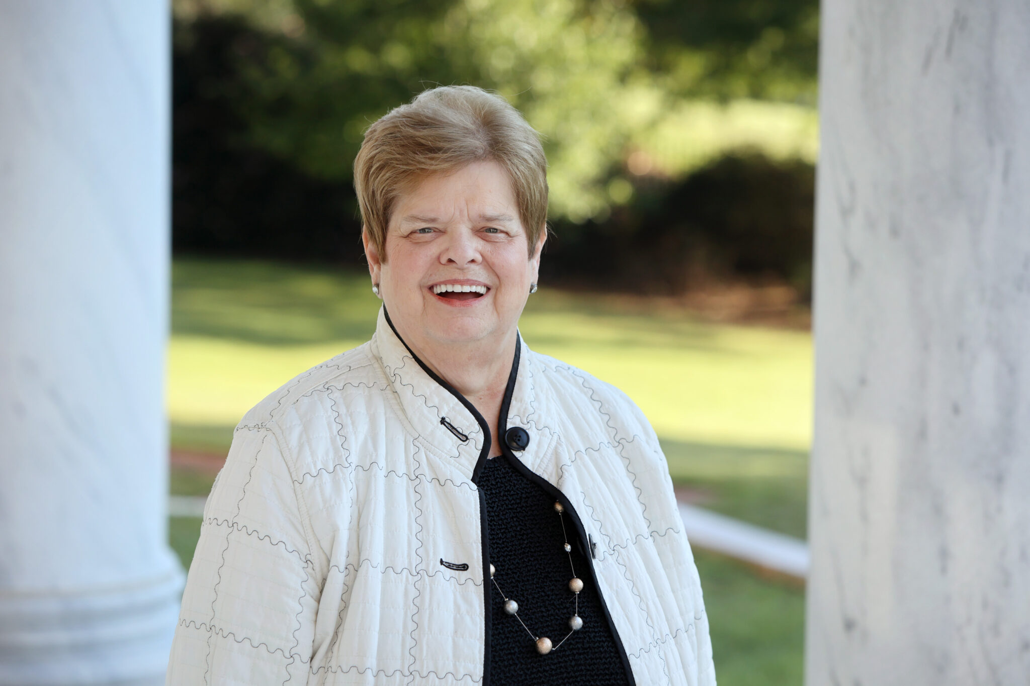 Billie Jo Kaufman smiling on the porch of the law school