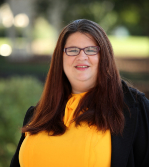 Photo of Michelle Hook Dewey with trees in the background