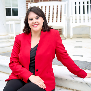 Image of Catherine Priebe sitting on the law school front porch