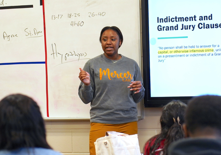 Image of Cire Foston teaching to a high school class during Civics Field Placement course