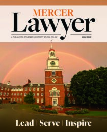 Cover of magazine with image of Mercer Law School clock tower and a rainbow behind it