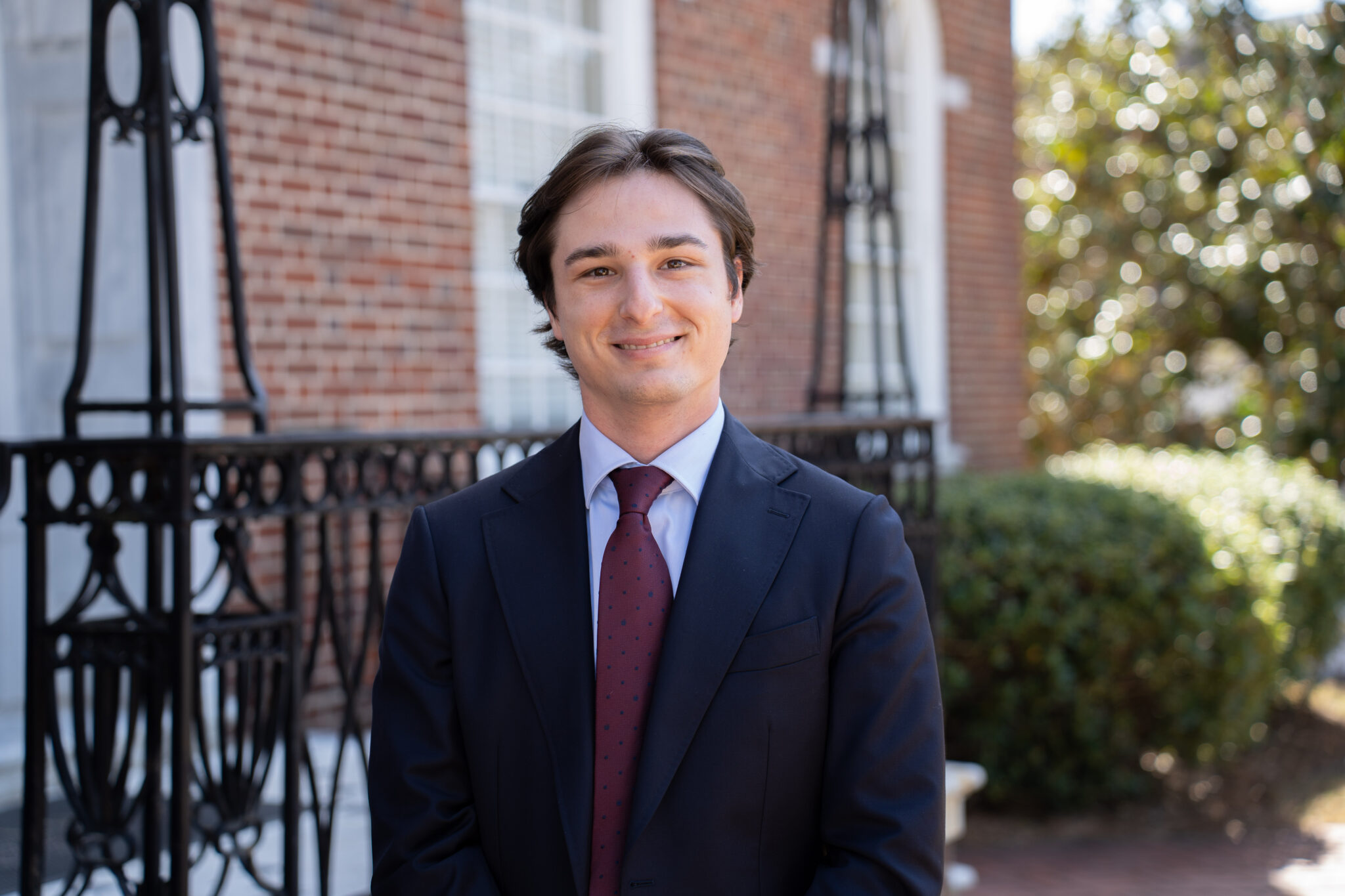 Seth Lewis standing in front of the law school's iron banister