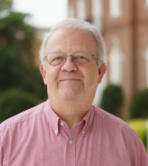 Steve Lindsey stands outside in a red shirt