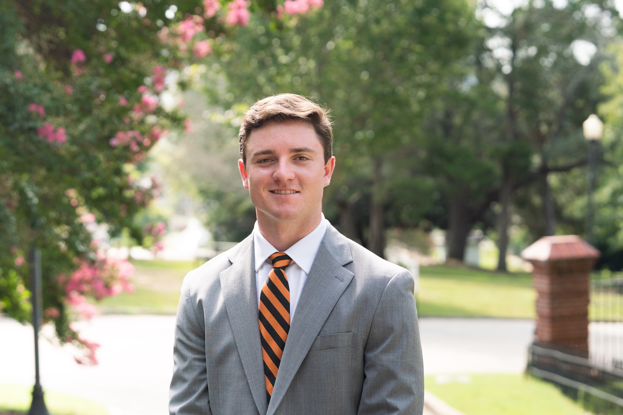 Trippe Moore stands outside in front of a tree